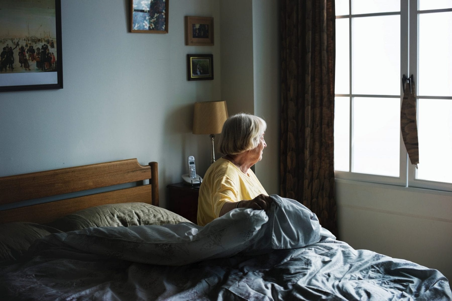Elderly woman in bed at nursing home