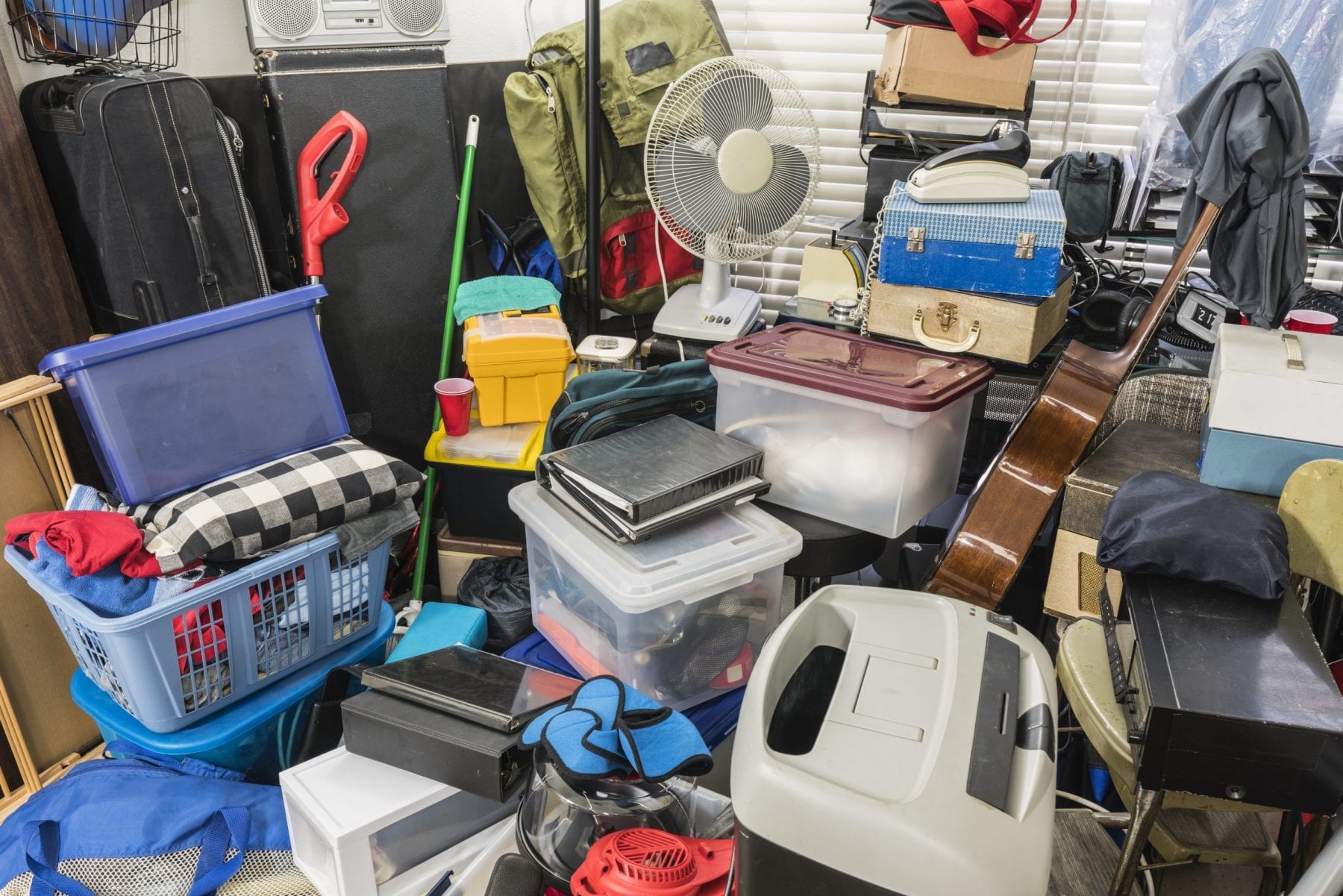 Home packed with stored boxes, vintage electronics, files, business equipment and household items.