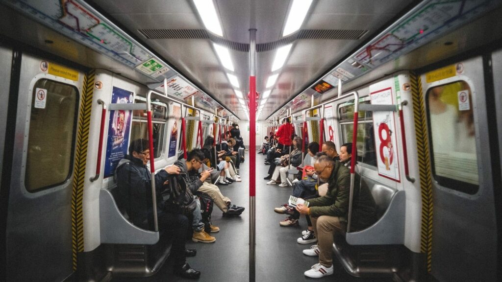 Group of people sitting riding on the subway