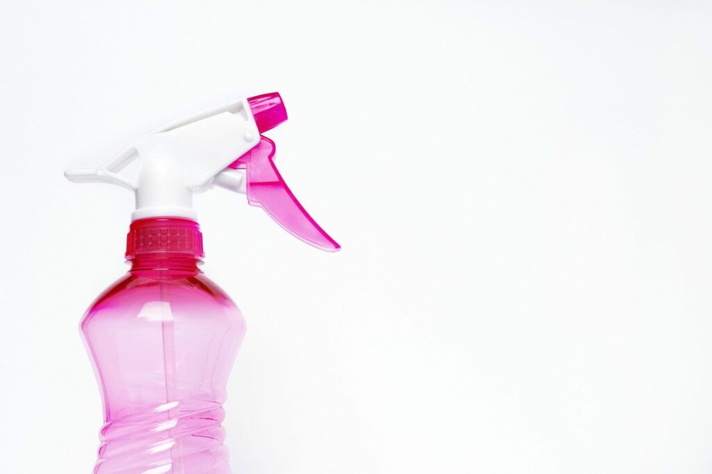 Pink and white spray bottle white background
