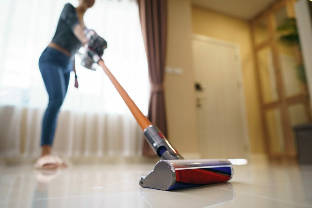 Woman running vacuum to clean the floor