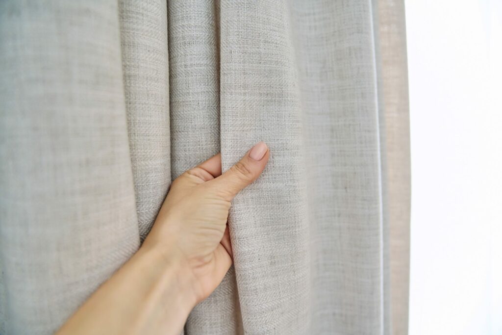 Light beige sand linen natural curtains on the window.